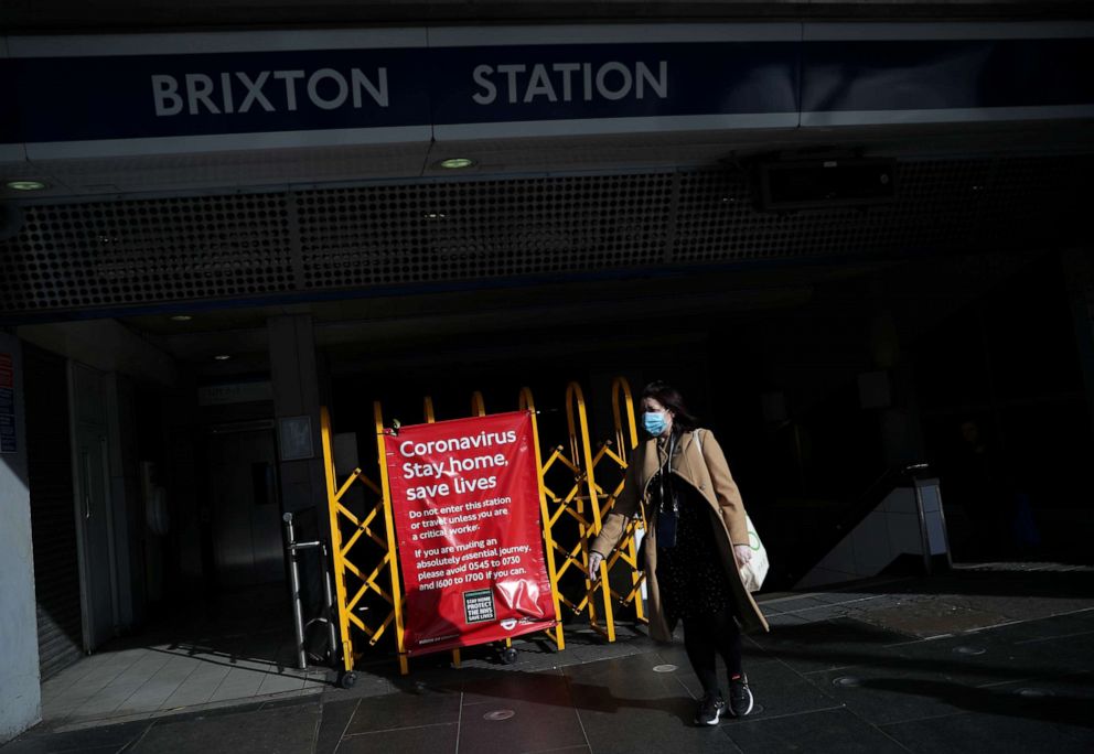 PHOTO: A woman wearing a protective face mask is seen leaving Brixton Station, as the spread of the coronavirus disease continues, London, April 3, 2020.