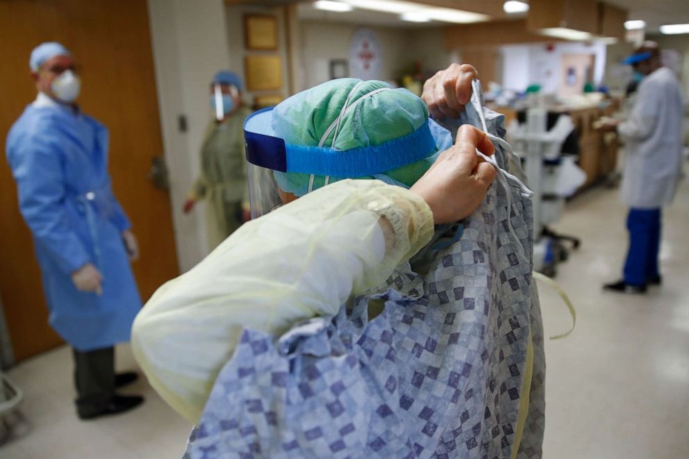 PHOTO: A nurse unties her gown after tending to a COVID-19 patient in the Intensive Care Unit, Monday, April 20, 2020, at St. Joseph's Hospital in Yonkers, N.Y.