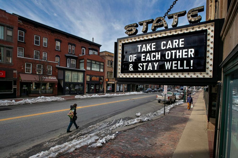 PHOTO: Pedestrians keep their distance in downtown Portland, Maine, just hours before a stay-at-home order goes into effect Wednesday, March 25, 2020, that will close all but essential workplaces in the city.