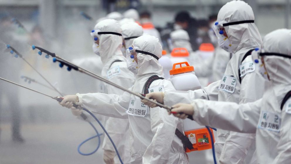 PHOTO: Soldiers wearing protective gear spray disinfectant as part of preventive measures against the spread of the coronavirus, at Dongdaegu railway station in Daegu, South Korea, Feb. 29, 2020. 