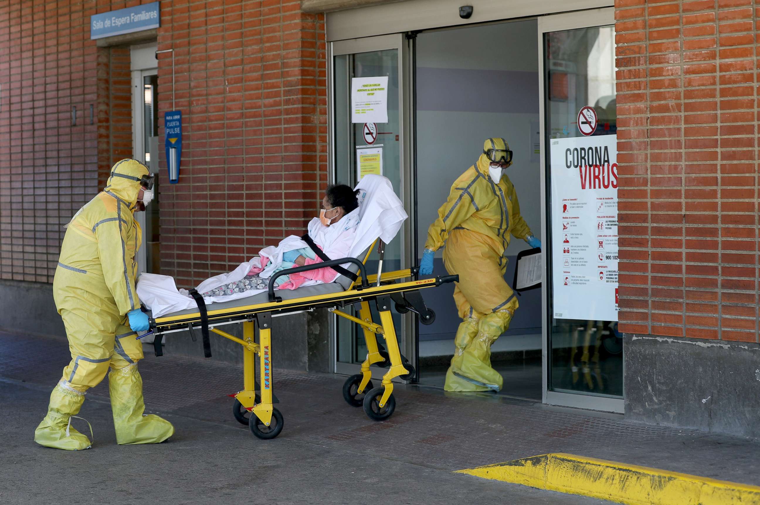 PHOTO: Ambulance workers in full protective gear arrive with a patient at the Severo Ochoa Hospital during the coronavirus outbreak in Leganes, Spain, March 26, 2020. 