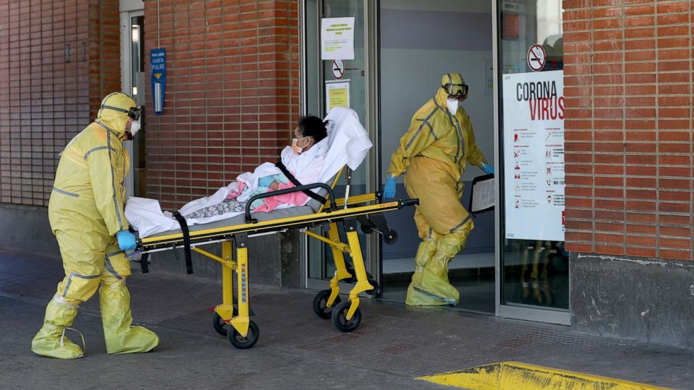 PHOTO: Ambulance workers in full protective gear arrive with a patient at the Severo Ochoa Hospital during the coronavirus outbreak in Leganes, Spain, March 26, 2020. 
