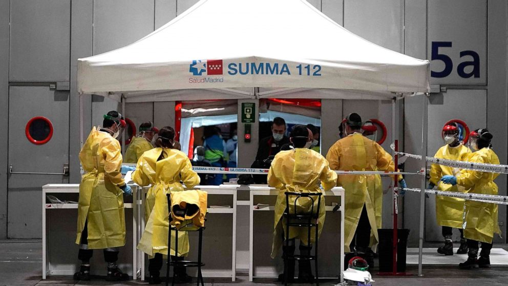 PHOTO: Health workers prepare for the arrival of patients at the temporary hospital set up for coronavirus patients at a pavilion in Ifema convention and exhibition center in Madrid, March 21, 2020. 