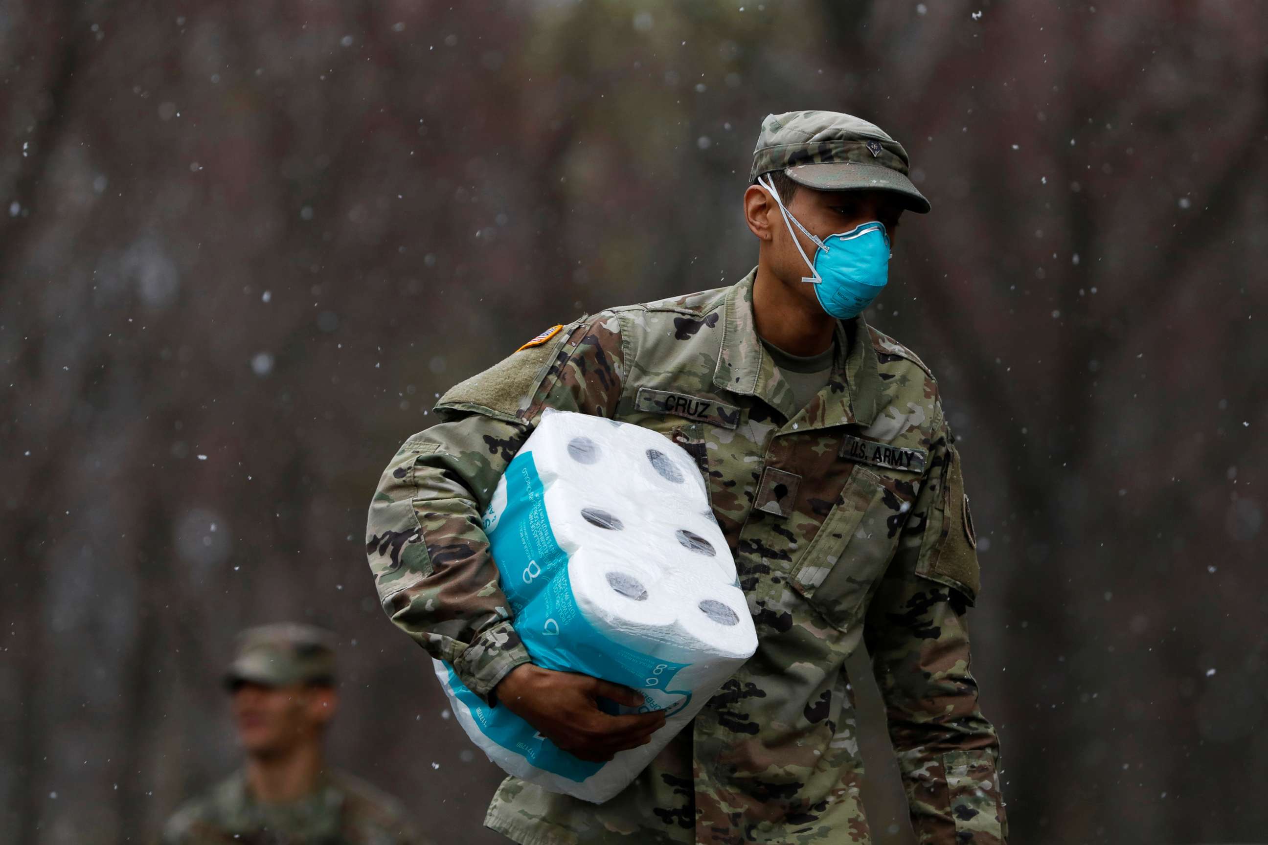 PHOTO: A member of Joint Task Force 2, composed of soldiers and airmen from the New York Army and Air National Guard, wears a face mask while carrying paper towels during the coronavirus outbreak in New Rochelle, N.Y., March 23, 2020. 