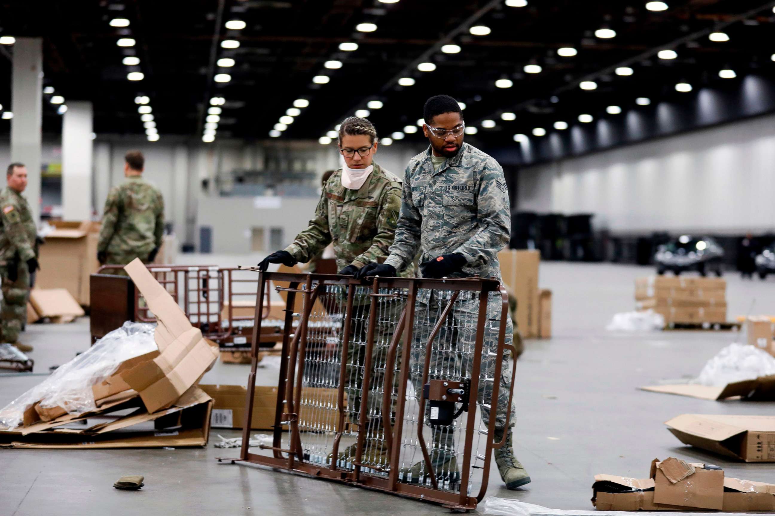 PHOTO: Members of the Michigan National Guard assemble beds at the TCF Center which is being converted by the US Army Corps of Engineers into a field hospital in Detroit, April 1, 2020. 