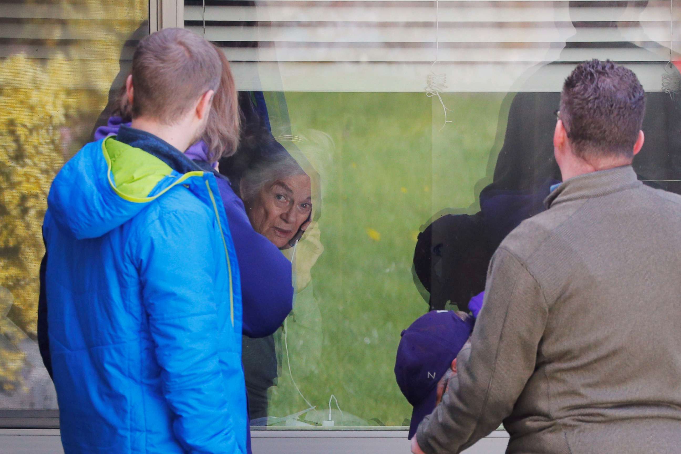 PHOTO: Judie Shape, 81, who has tested positive for coronavirus, visits with her extended family through her window at the Life Care Center of Kirkland, the Seattle-area nursing home in Kirkland, Wash., March 14, 2020. 