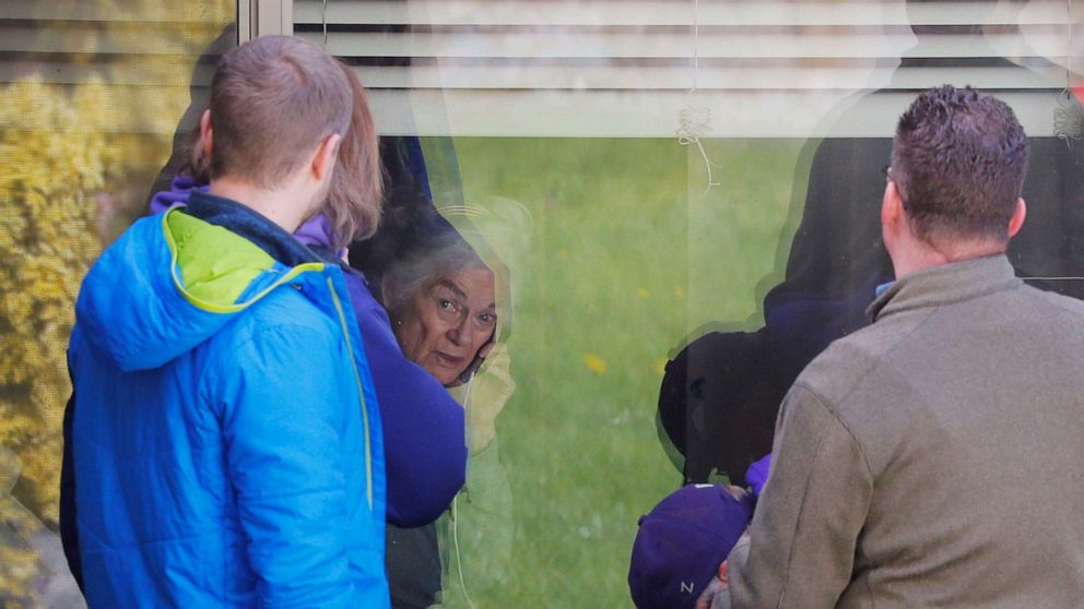 PHOTO: Judie Shape, 81, who has tested positive for coronavirus, visits with her extended family through her window at the Life Care Center of Kirkland, the Seattle-area nursing home in Kirkland, Wash., March 14, 2020. 