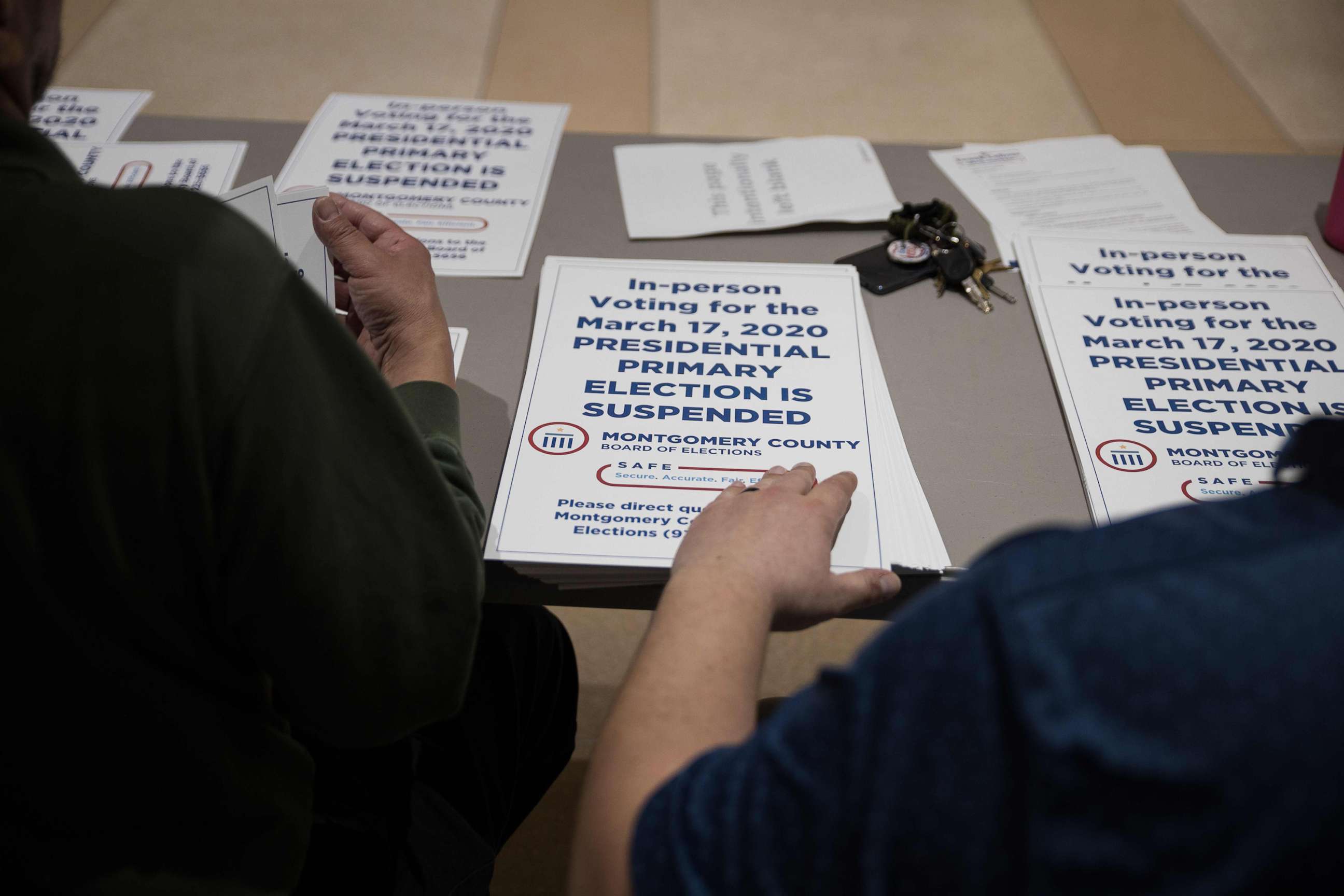 PHOTO: County election workers hand out  election delayed signs to put up at polling stations in Dayton, Ohio, March 17, 2020, after the primaries were canceled.