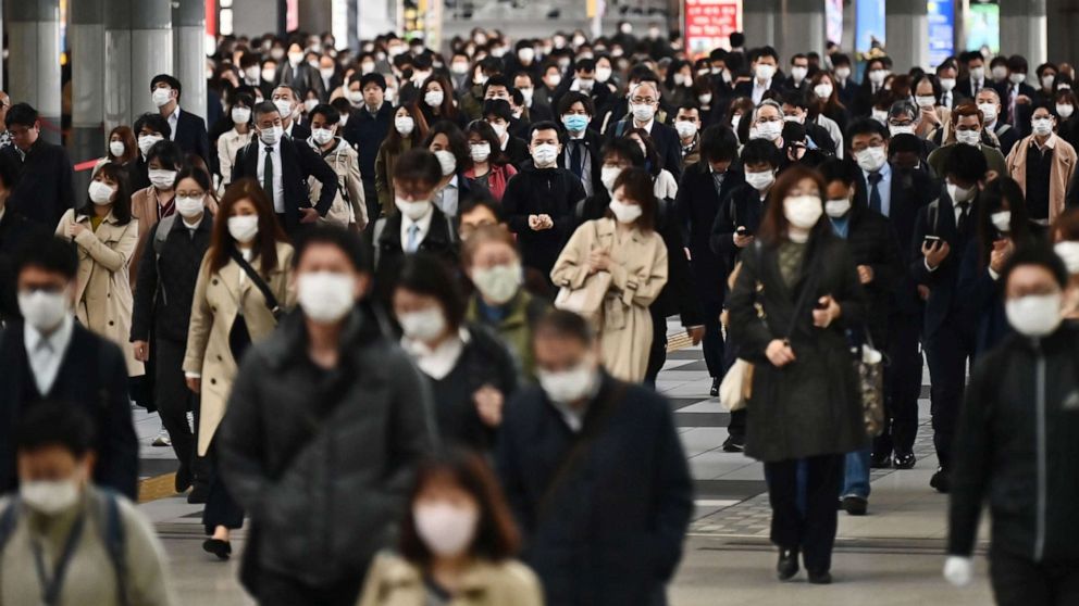 PHOTO: People commute to work despite a state of emergency in Japan at Shinagawa station in Tokyo, April 16, 2020. 