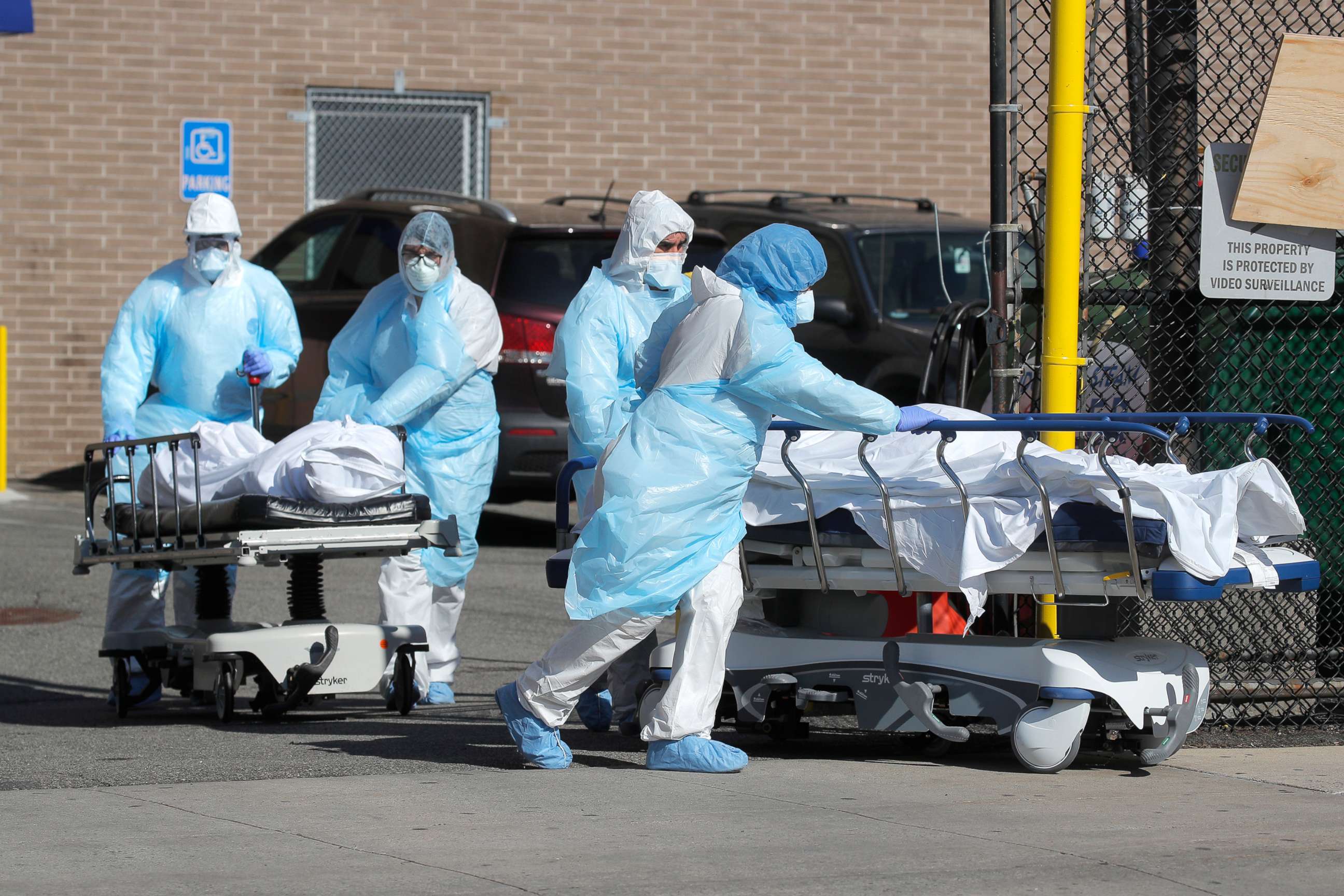 PHOTO: Healthcare workers wheel the bodies of deceased people outside the Wyckoff Heights Medical Center during the outbreak of the coronavirus disease (COVID-19) in Brooklyn, New York, April 6, 2020. 