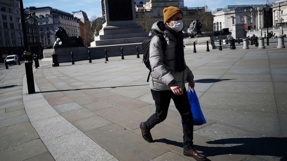 PHOTO: A man wears a mask in Trafalgar Square as the spread of the coronavirus continues, in London, March 23, 2020. 
