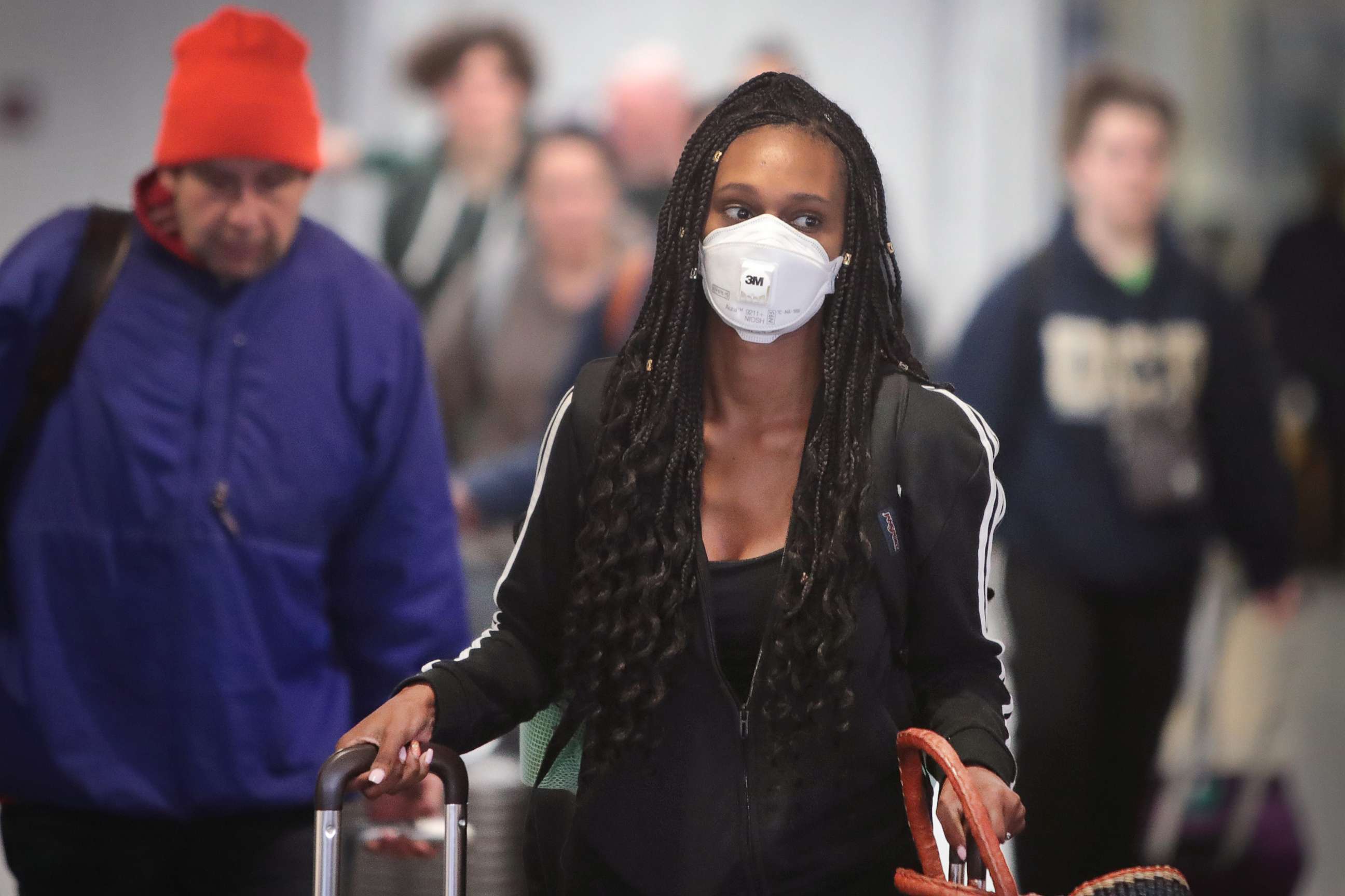PHOTO: Travelers arrive in the international terminal at O'Hare Airport, March 15, 2020, in Chicago.