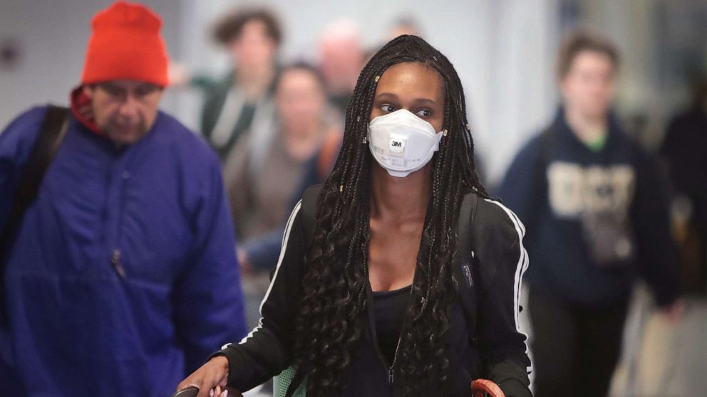 PHOTO: Travelers arrive in the international terminal at O'Hare Airport, March 15, 2020, in Chicago.