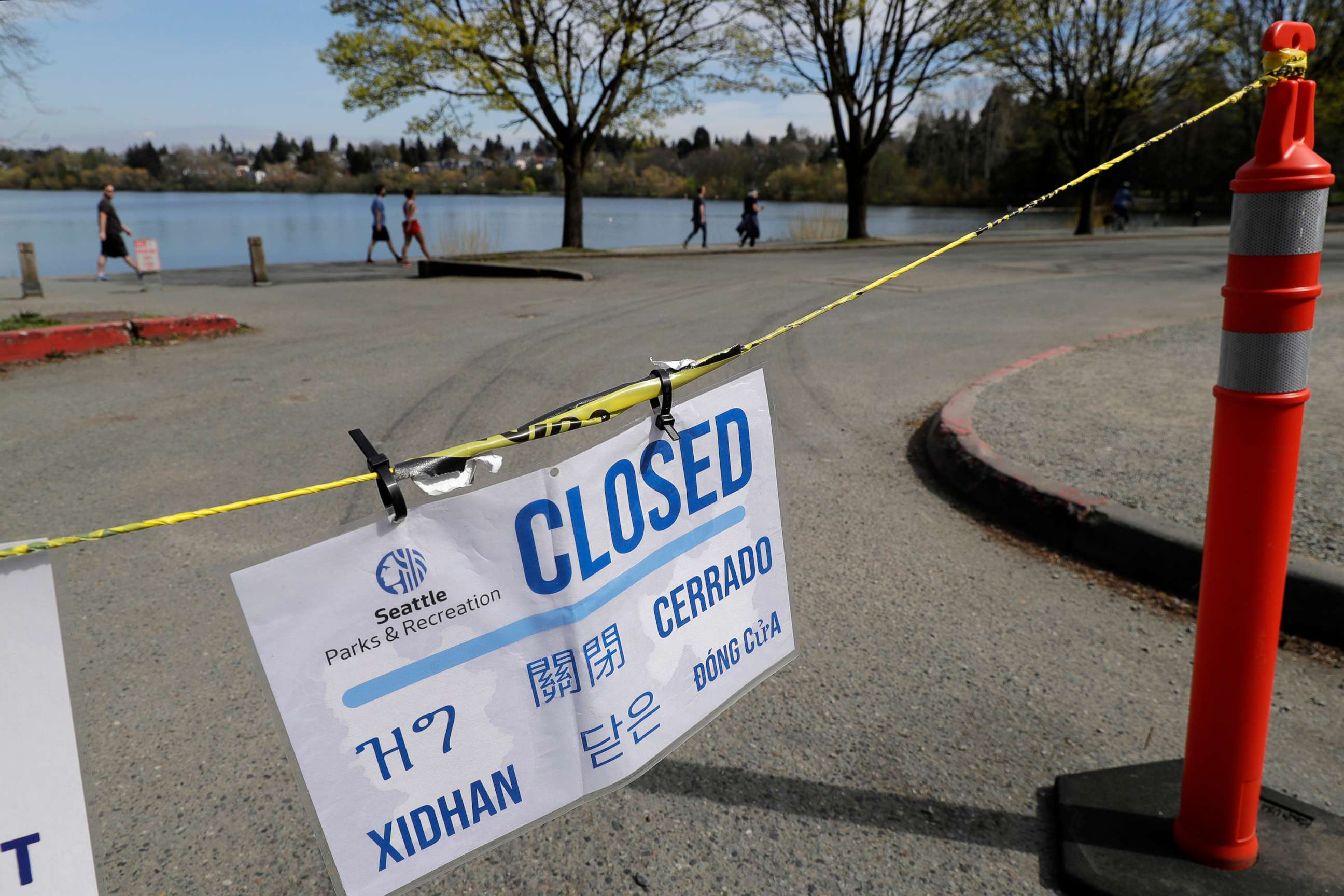 PHOTO: A sign showing a parking lot at Green Lake Park is closed due to the coronavirus outbreak is shown, April 10, 2020, in Seattle. 