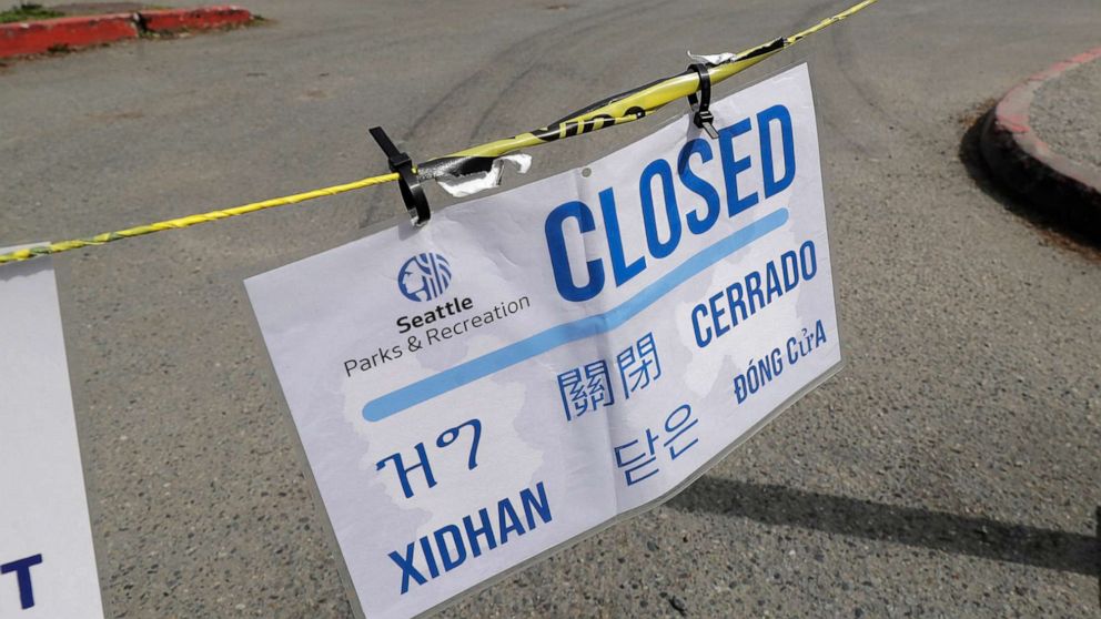 PHOTO: A sign showing a parking lot at Green Lake Park is closed due to the coronavirus outbreak is shown, April 10, 2020, in Seattle. 