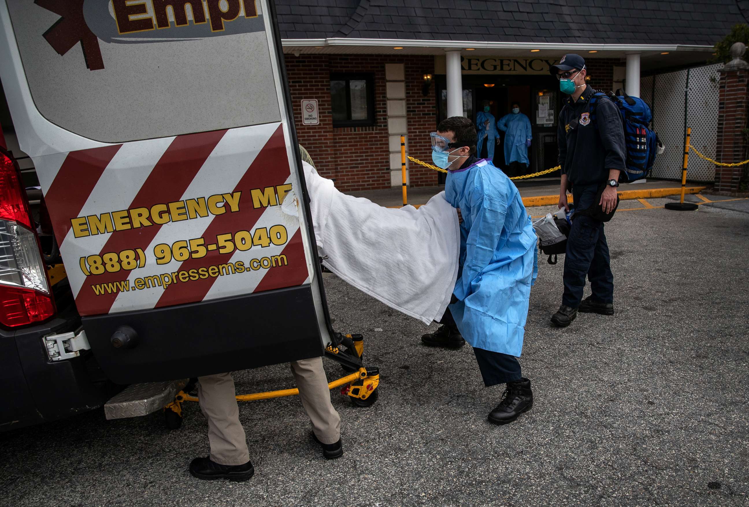 PHOTO: A medic from Empress EMS loads a suspected COVID-19 patient from the Regency Extended Care Center into an ambulance, April 7, 2020, in Yonkers, New York. 