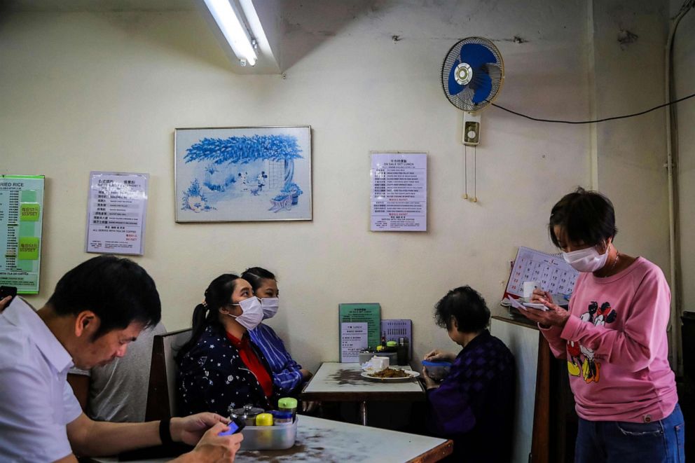 PHOTO: Customers wearing face masks amid concerns about the spread of coronavirus give their orders inside a restaurant, in Hong Kong, March 1, 2020.