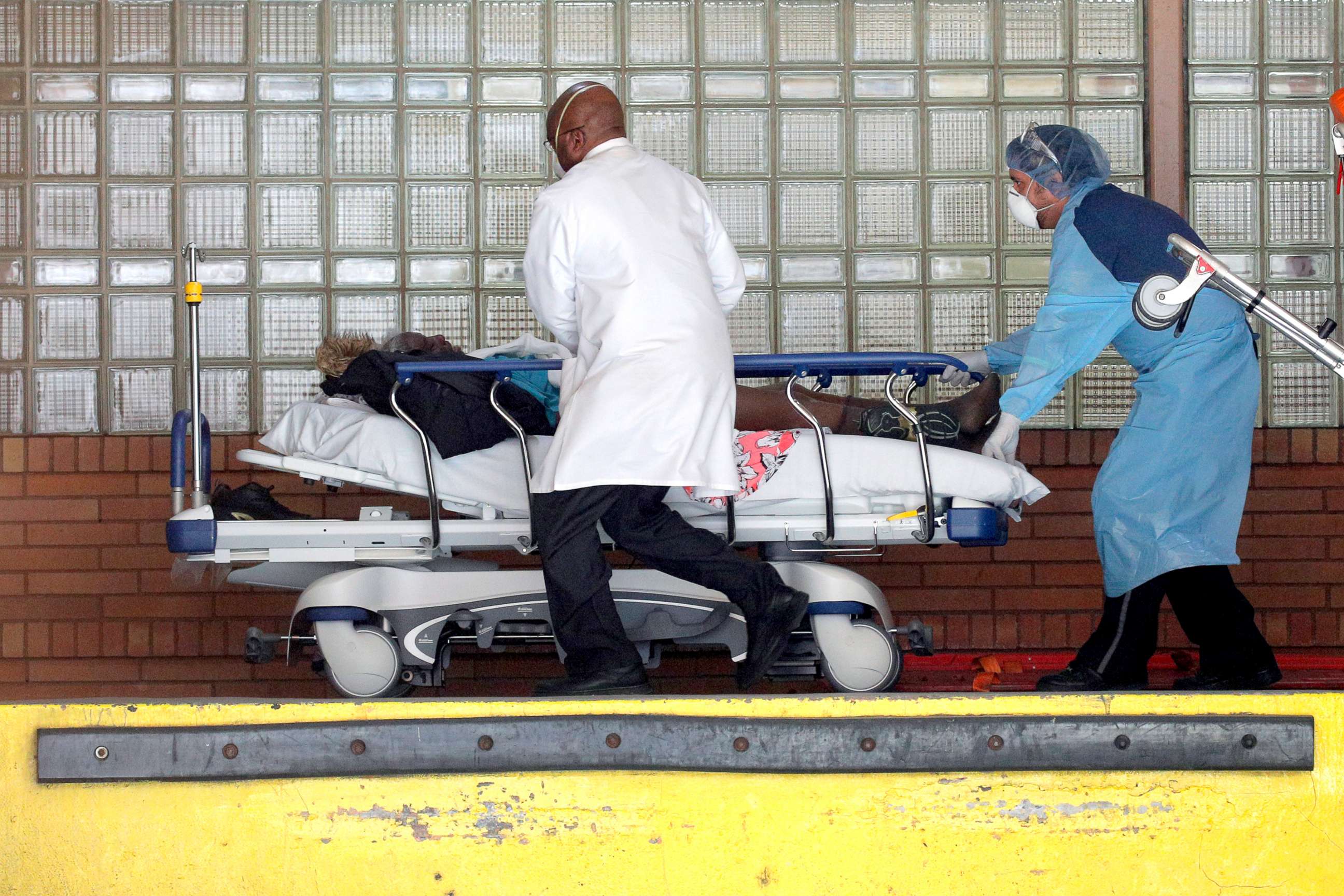 PHOTO: Healthcare workers rush a patient on a stretcher into the Wyckoff Heights Medical Center during the outbreak of the coronavirus disease (COVID-19) in Brooklyn, New York, April 6, 2020. 