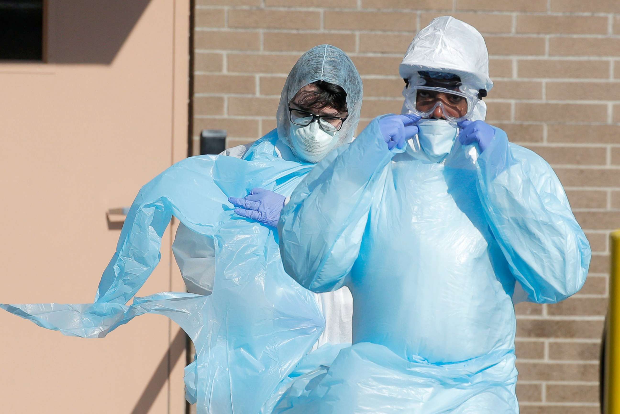 PHOTO: Healthcare workers walk in personal protective equipment outside the Wyckoff Heights Medical Center during the outbreak of the coronavirus disease (COVID-19) in Brooklyn, New York, April 6, 2020. 