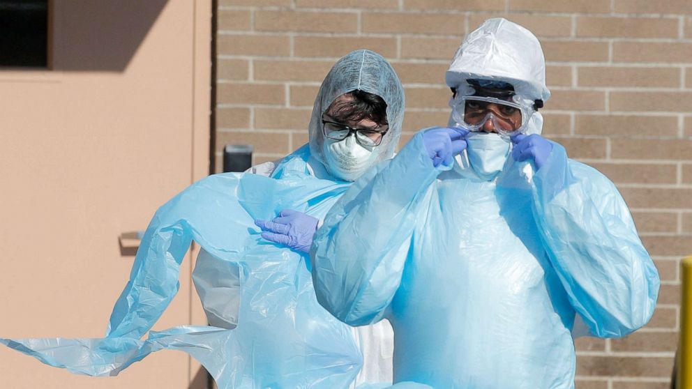 PHOTO: Healthcare workers walk in personal protective equipment outside the Wyckoff Heights Medical Center during the outbreak of the coronavirus disease (COVID-19) in Brooklyn, New York, April 6, 2020. 