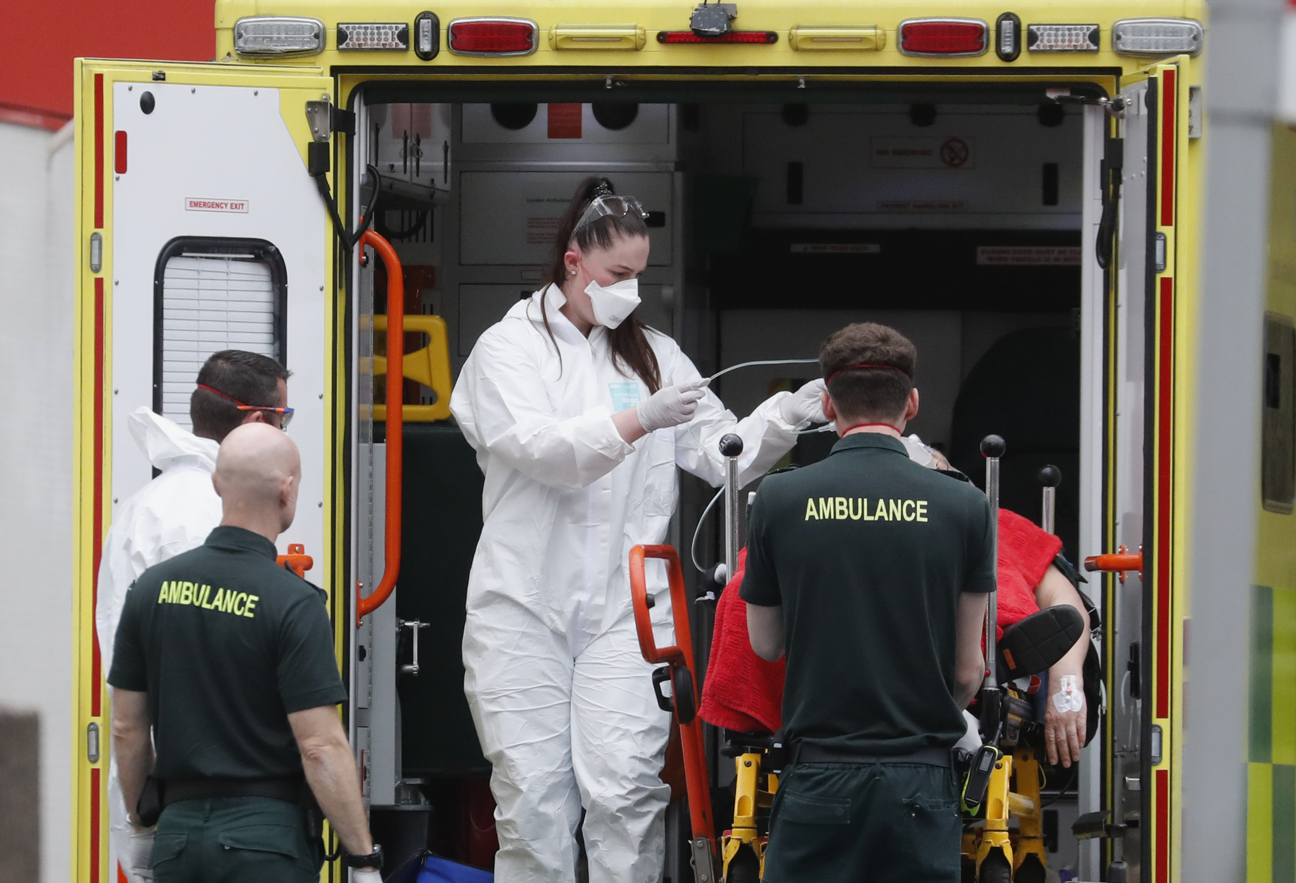 PHOTO: Medical workers wearing equipment to protect themselves from coronavirus bring a patient to St Thomas' Hospital in Westminster in London, April 6, 2020.