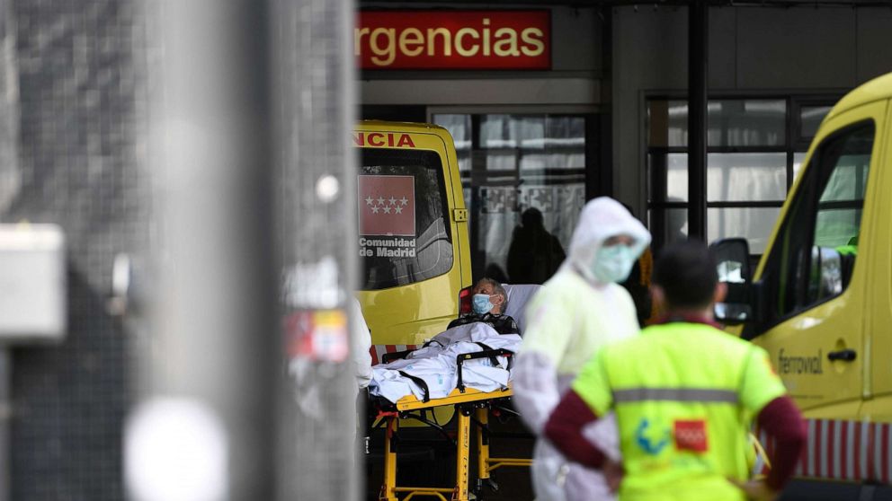 PHOTO: A man wearing a face mask is wheeled into La Paz hospital in Madrid, March 23, 2020, amid a national lockdown to fight the spread of the coronavirus. 
