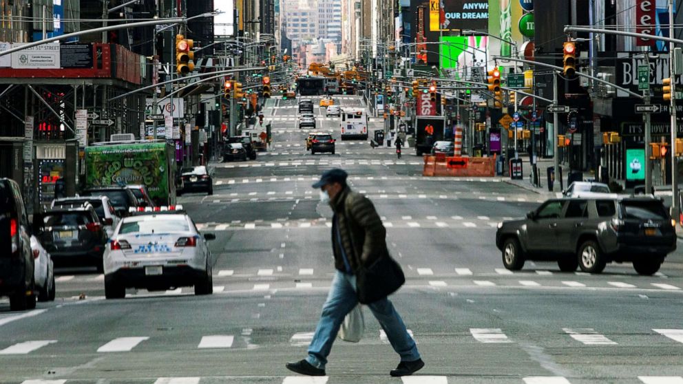 PHOTO: People walk around Times Square as the coronavirus disease (COVID-19) outbreak continues in New York, March 22, 2020.  