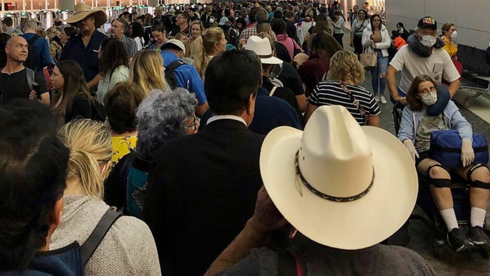 PHOTO: People wait in line to go through the customs at Dallas Fort Worth International Airport in Grapevine, Texas, March 14, 2020.