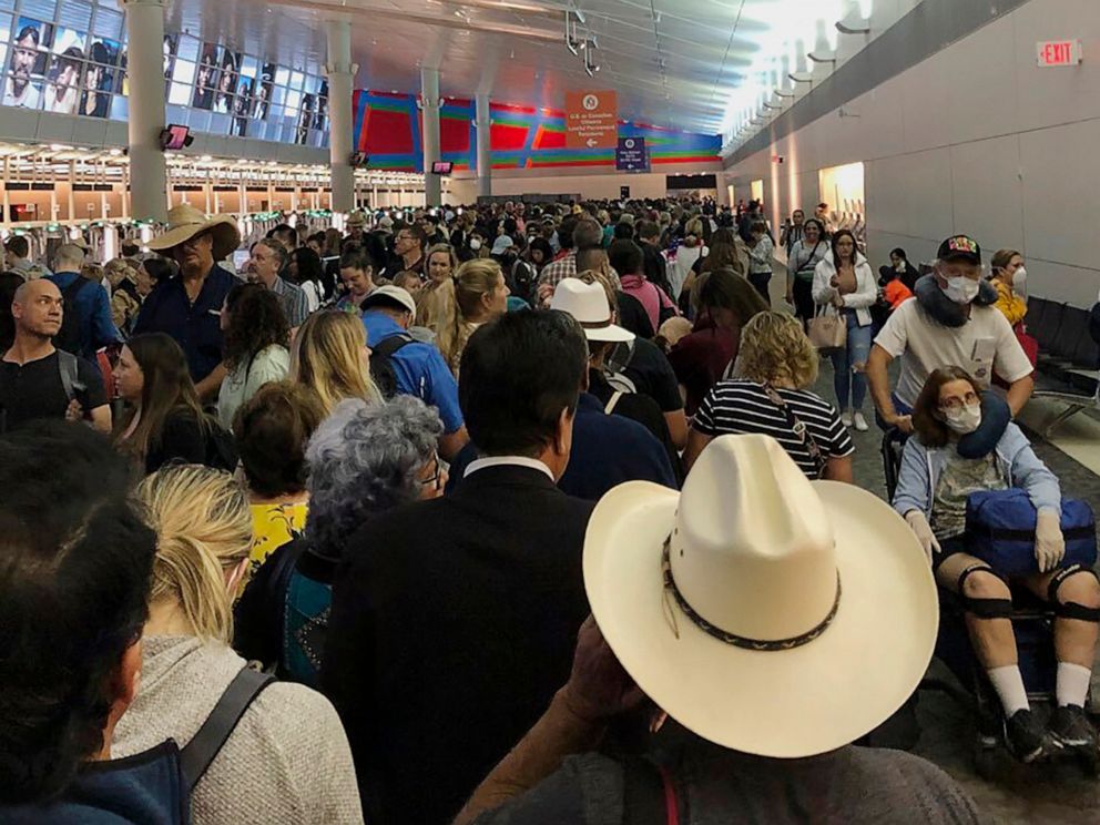 PHOTO: People wait in line to go through the customs at Dallas Fort Worth International Airport in Grapevine, Texas, March 14, 2020.