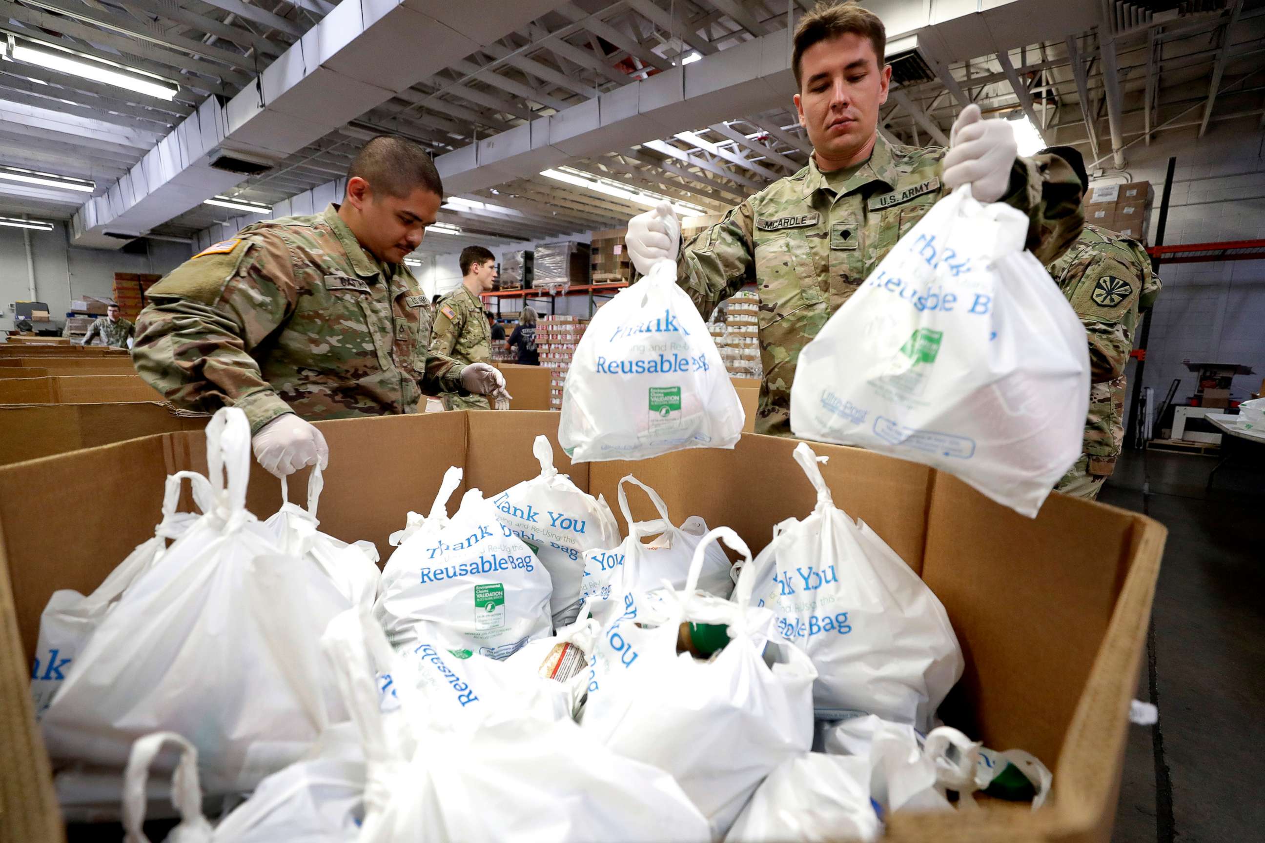 PHOTO: Arizona National Guard members pack and sort food items at a food bank, March 26, 2020, in Mesa, Ariz.