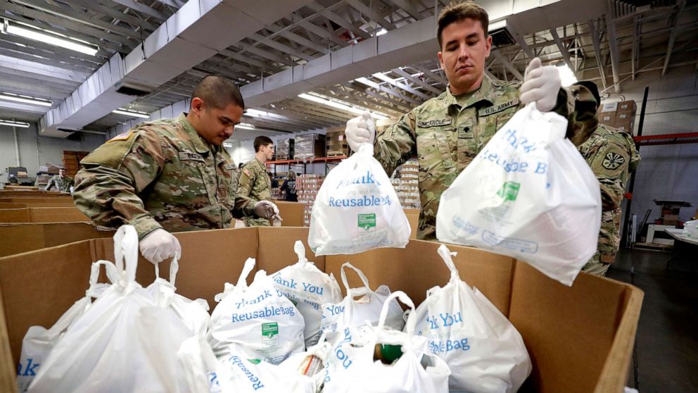 PHOTO: Arizona National Guard members pack and sort food items at a food bank, March 26, 2020, in Mesa, Ariz.