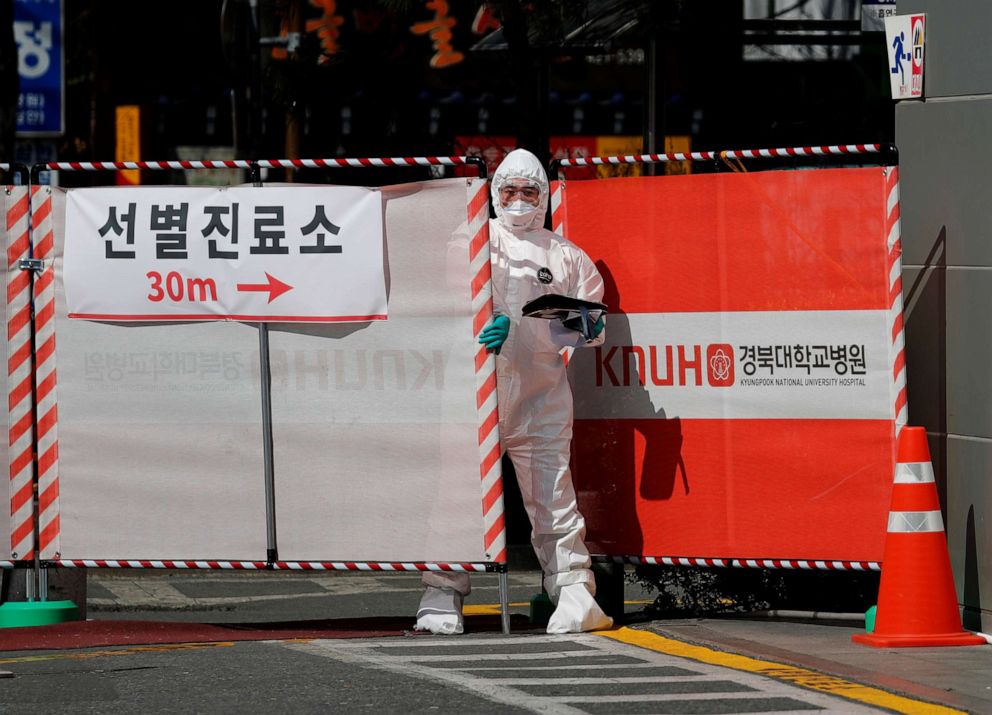 PHOTO: A medical worker in a protective gear closes a gate to the screening center for novel coronavirus at Kyungpook National University Hospital in Daegu, South Korea, March 6, 2020.