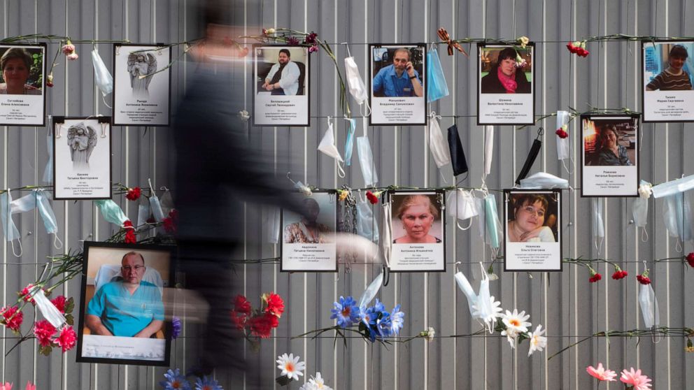 PHOTO: Medical face masks and portraits of St.Petersburg's medical workers who died from coronavirus infection during their work, hang at a unofficial memorial in front of the local health department in St.Petersburg, Russia, May 14, 2020.