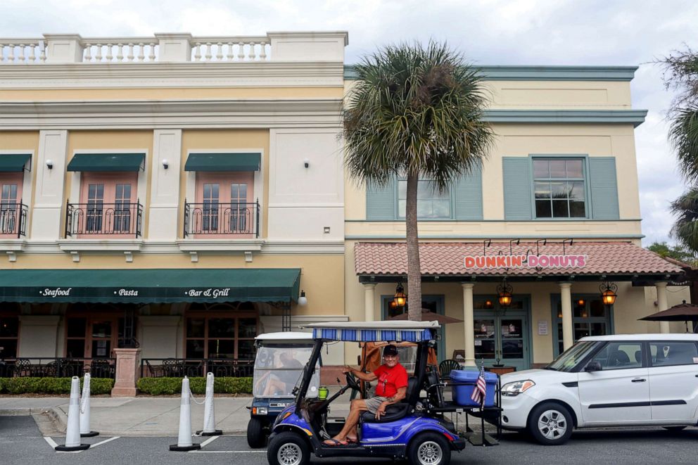 PHOTO: Retiree Al Berliner, 73, sits in his golf cart at Spanish Springs Town Square amid coronavirus (COVID-19) cases in The Villages, Fla., March 16, 2020. 