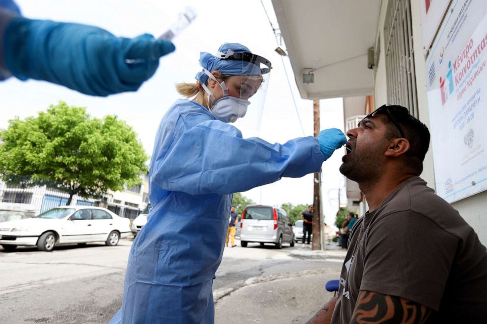 PHOTO: Medical workers wearing special suits to protect against coronavirus, conduct testing for COVID-19 at a Roma neighborhood, in Larissa city, central Greece, May 18, 2020.