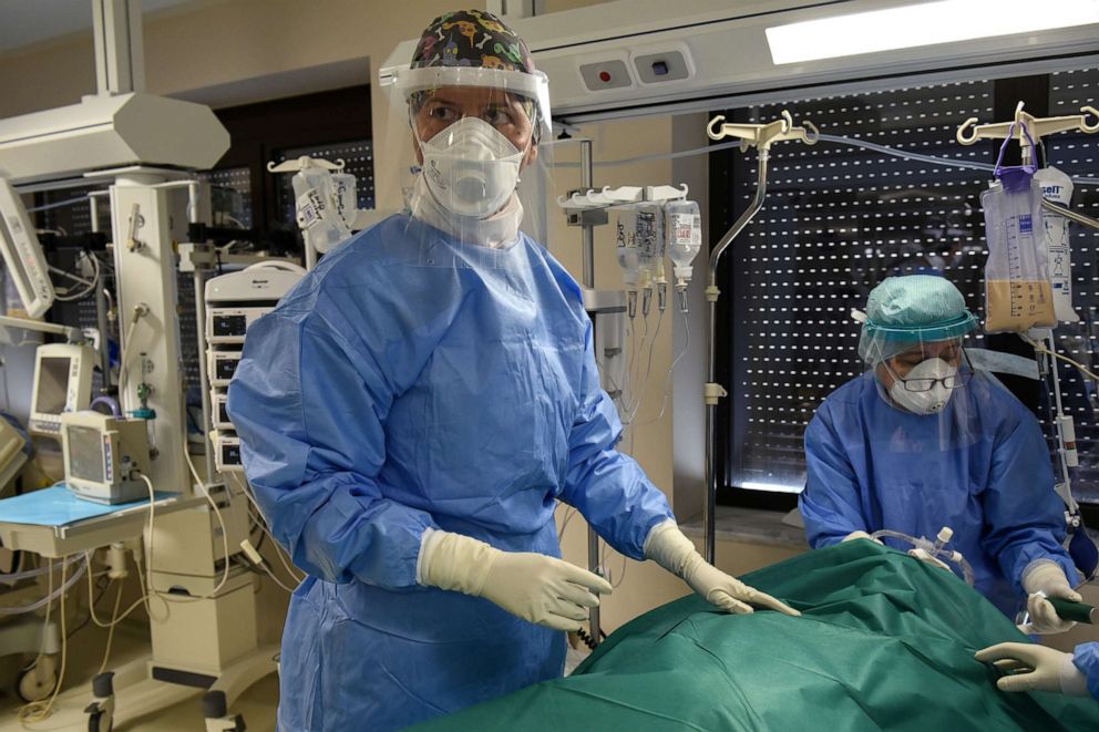 PHOTO: Medical workers wearing personal protective equipment prepare to perform a tracheotomy on a patient in the ICU of the George Papanikolaou General Hospital, during the coronavirus disease pandemic in Thessaloniki, Greece, Nov. 11, 2020.