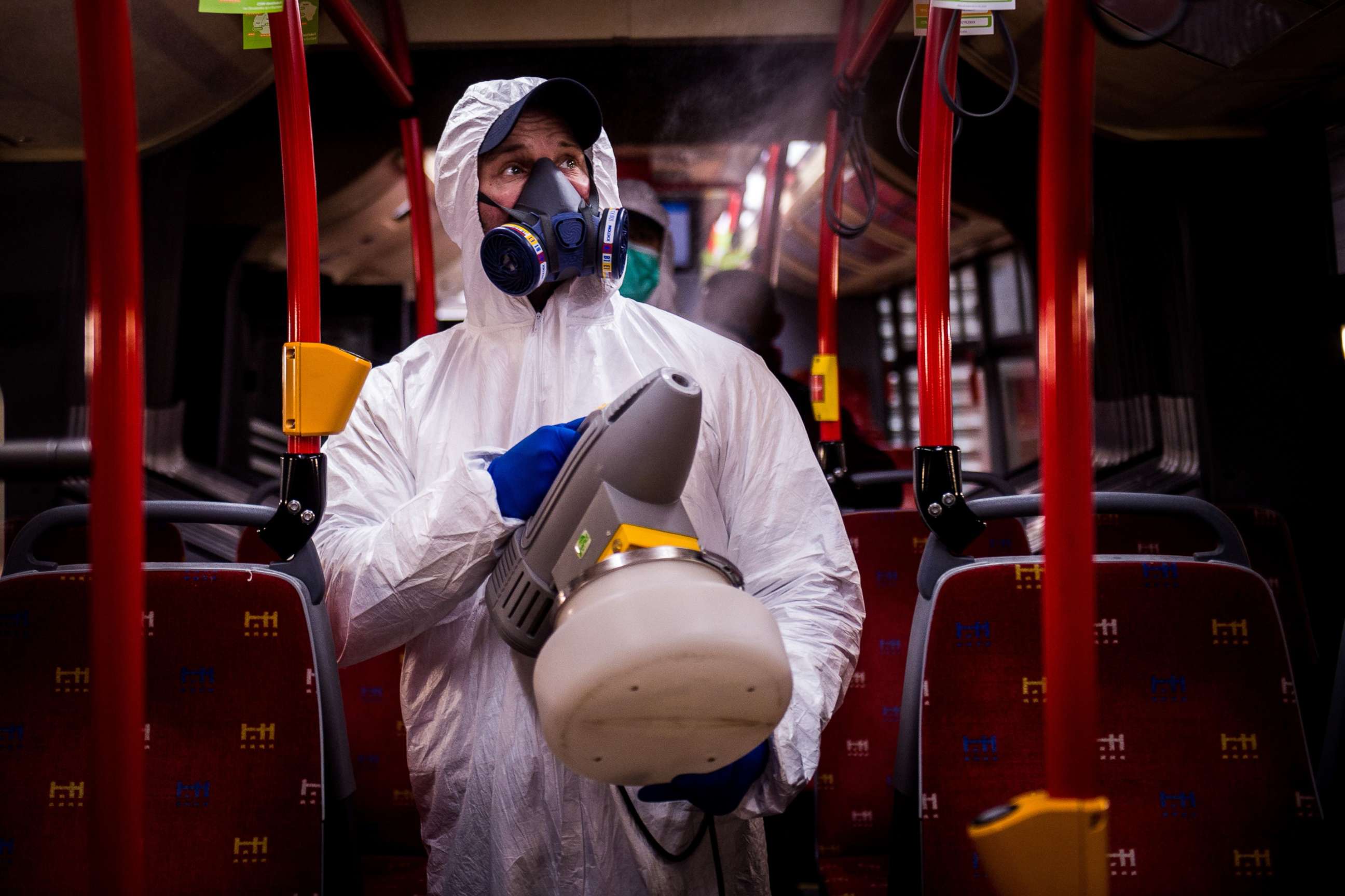 PHOTO: A worker wearing protective clothes disinfects an interior of a public bus in Bratislava, Slovakia, March 11, 2020. 