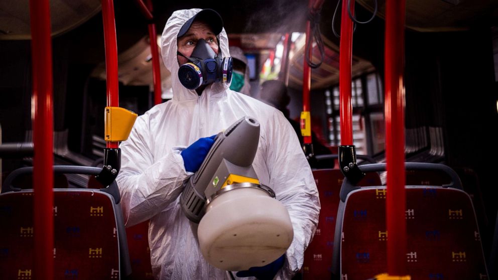 PHOTO: A worker wearing protective clothes disinfects an interior of a public bus in Bratislava, Slovakia, March 11, 2020. 