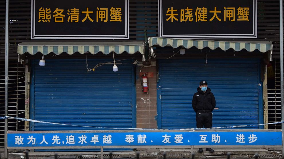 PHOTO: A security guard stands outside the Huanan Seafood Wholesale Market where the coronavirus was detected in Wuhan on January 24, 2020. 