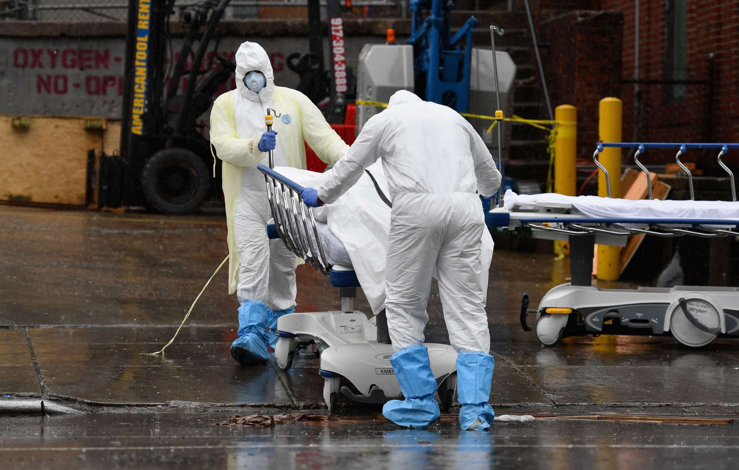 PHOTO: Medical personnel move a deceased patient to a refrigerated truck serving as make shift morgues at Brooklyn Hospital Center, April 9, 2020, in New York City.