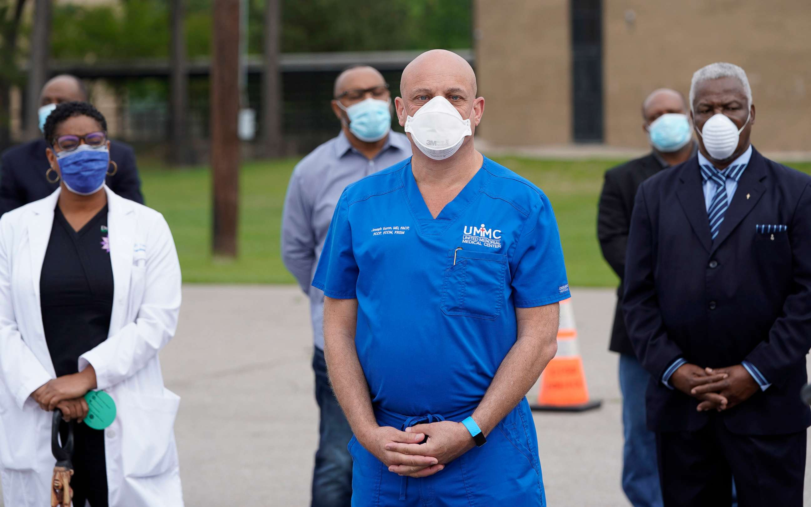 PHOTO: United Memorial Medical Center's Dr. Joseph Varon, center, practices social distancing while waiting to speak during a news conference at their newly opened free drive through Covid-19 testing site, April 2, 2020, in Houston.