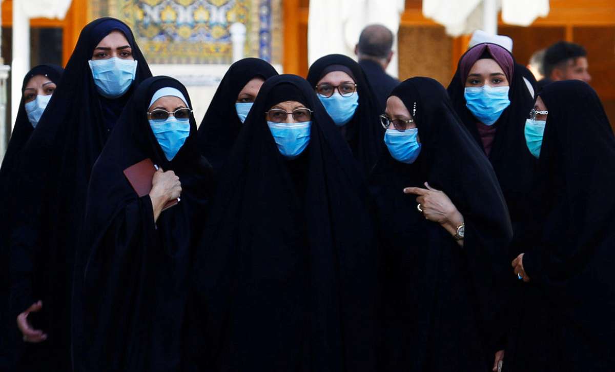 PHOTO: Shi'ite Muslims women wear protective face masks at Imam Ali Shrine, following an outbreak of coronavirus, in the holy city of Najaf, Iraq, March 11, 2020.