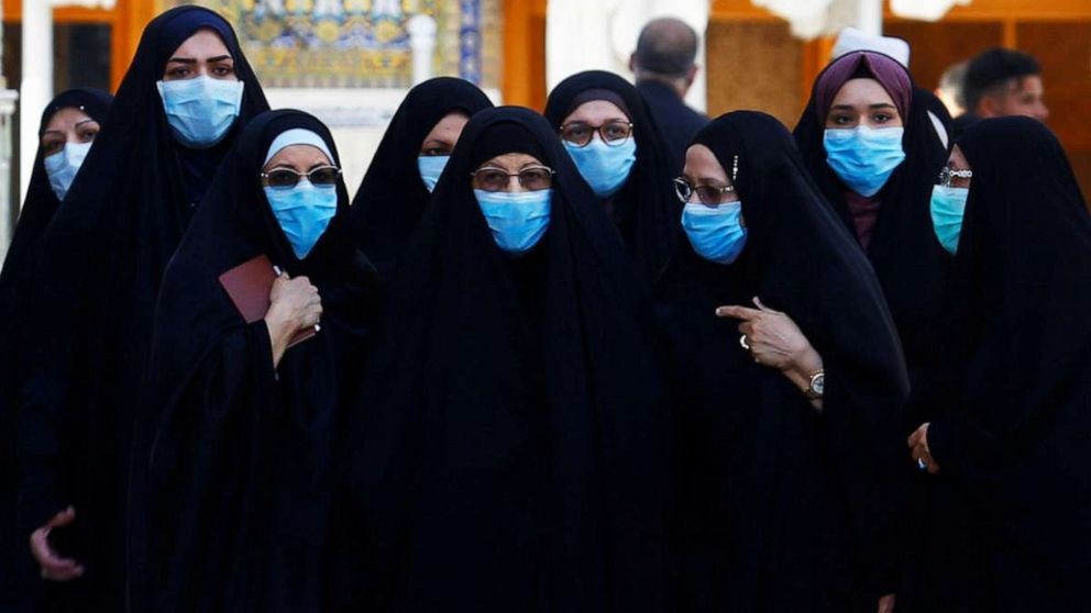 PHOTO: Shi'ite Muslims women wear protective face masks at Imam Ali Shrine, following an outbreak of coronavirus, in the holy city of Najaf, Iraq, March 11, 2020.