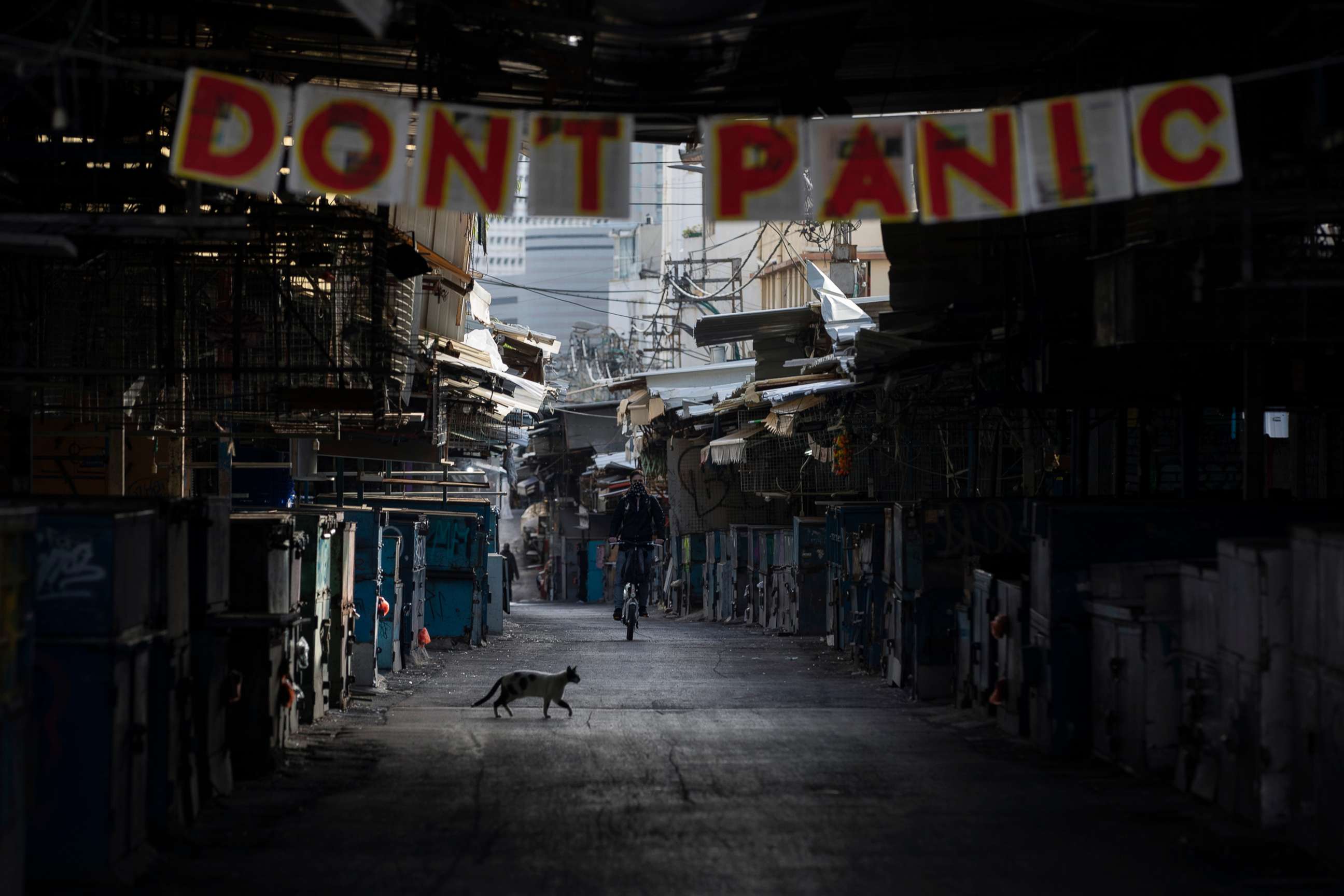 PHOTO: A "don't panic" sign hang on the entrance of a closed food market that was shut down in order to reduce the spread of the coronavirus, in Tel Aviv, Israel, March 23, 2020.