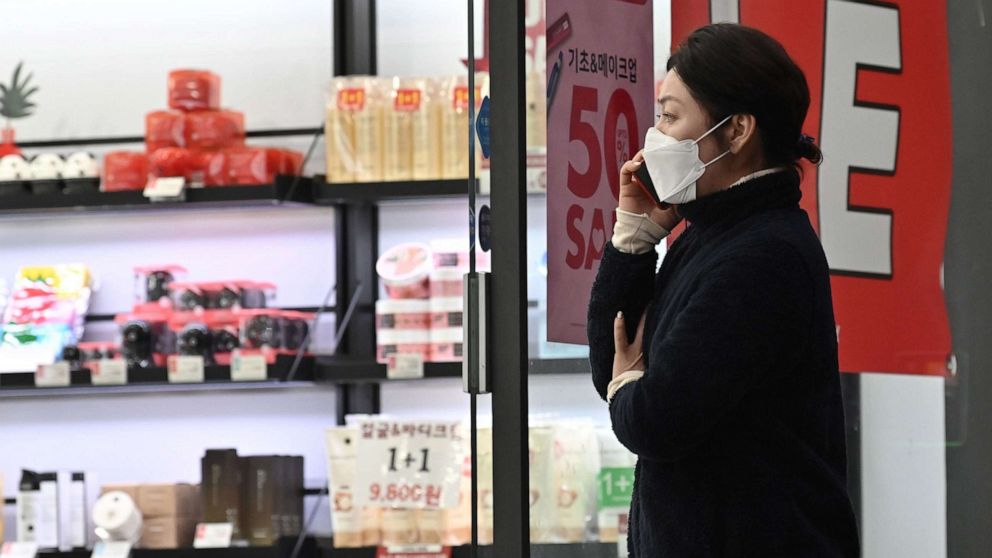 PHOTO: A woman wearing a face mask walks into a shop at Dongseongro shopping district in the southeastern city of Daegu, South Korea, Feb. 24, 2020.