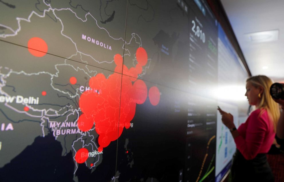 PHOTO: A reporter stands in front of a coronavirus global map during a tour of the "secretary's operation center" as part of a coronavirus task force meeting at the Department of Health and Human Services in Washington, D.C., Feb. 27, 2020.