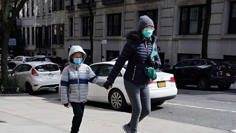 PHOTO: A woman and child wear protective masks during the coronavirus pandemic, on April 15, 2020, in New York City. 