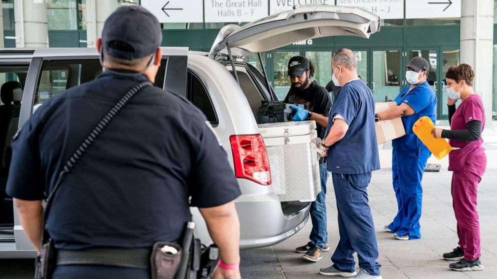 PHOTO: Workers from the Louisiana Department of Health transport medicine for Covid-19 patients to the New Orleans Ernest N. Morial Convention Center, April 6, 2020.