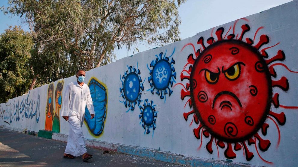 PHOTO: A Palestinian man walks past a coronavirus awareness mural in Deir al-Balah in the central Gaza Strip on Sept. 14, 2020.