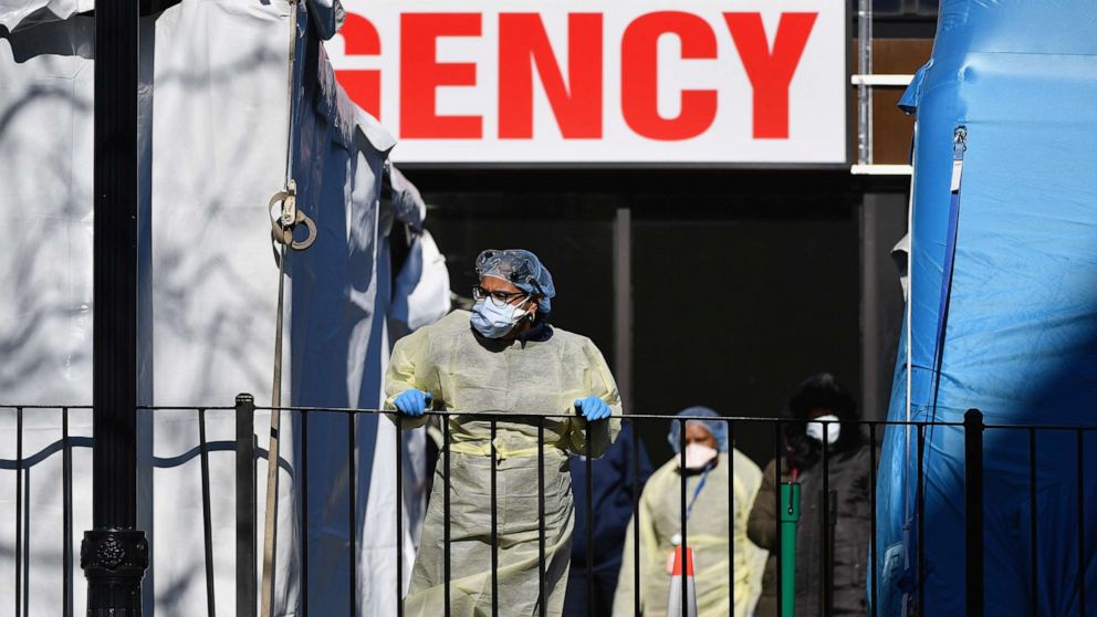 PHOTO: Medical workers outside Elmhurst Hospital Center, in the Queens borough of New York City, on March 26, 2020. The hospital reported 13 COVID-19 patients died in a 24-hour span.